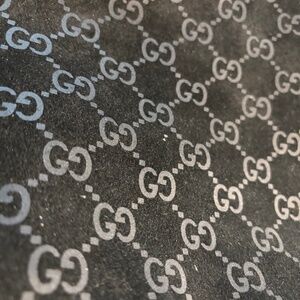Gucci black suede with embossed logo